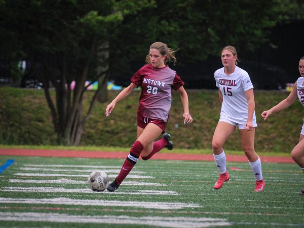 Junior Eve Namias runs down the field with the ball in the Knight's game against Central, where the girls won 10-0.