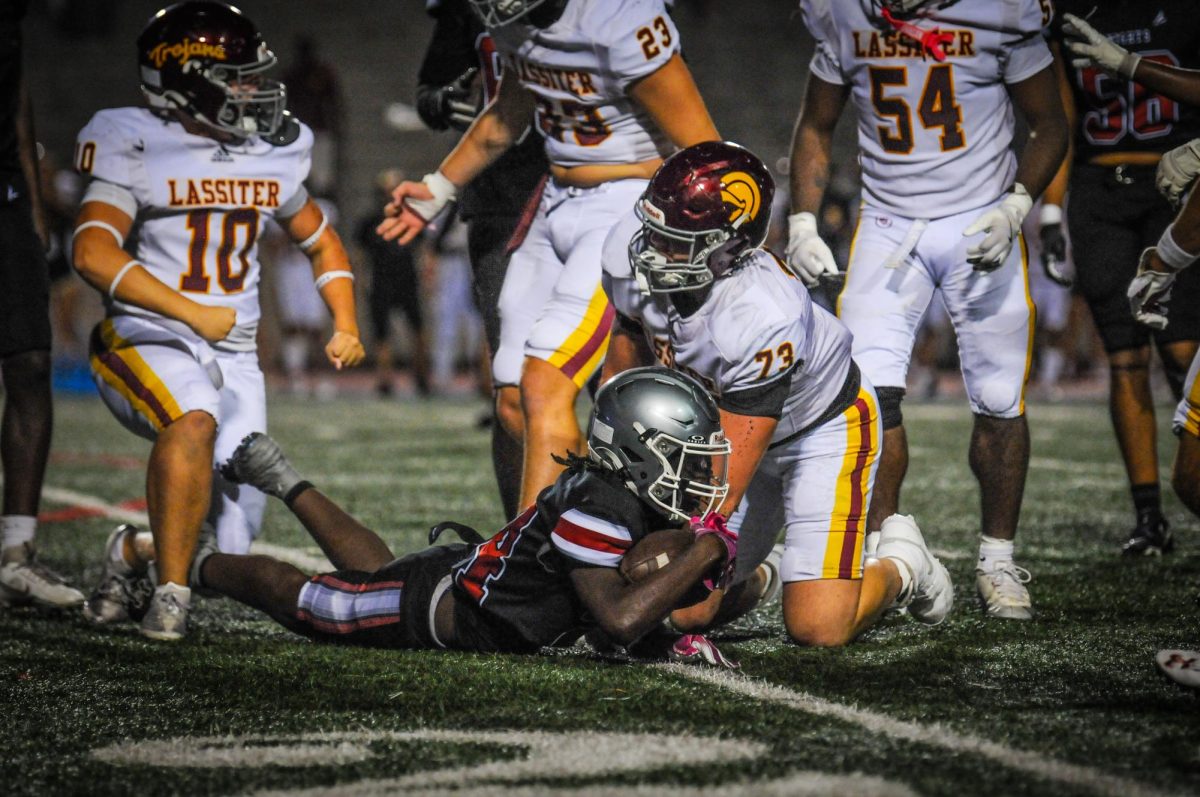 Junior running back Demetrius Wilcox holds football in defensive play against Lassiter High School on Aug. 15. The Knights lost 44-12. 