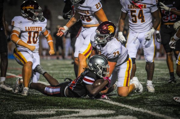 Junior running back Demetrius Wilcox holds football in defensive play against Lassiter High School on Aug. 15. The Knights lost 44-12. 