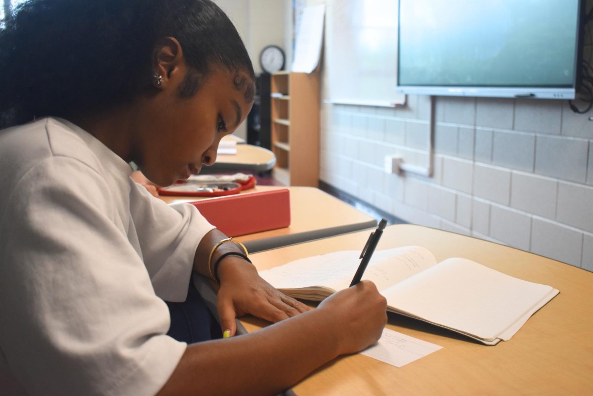 TEST READY: Sophomore Olivia Blalock copies her notes onto a notecard to prepare for an upcoming test.