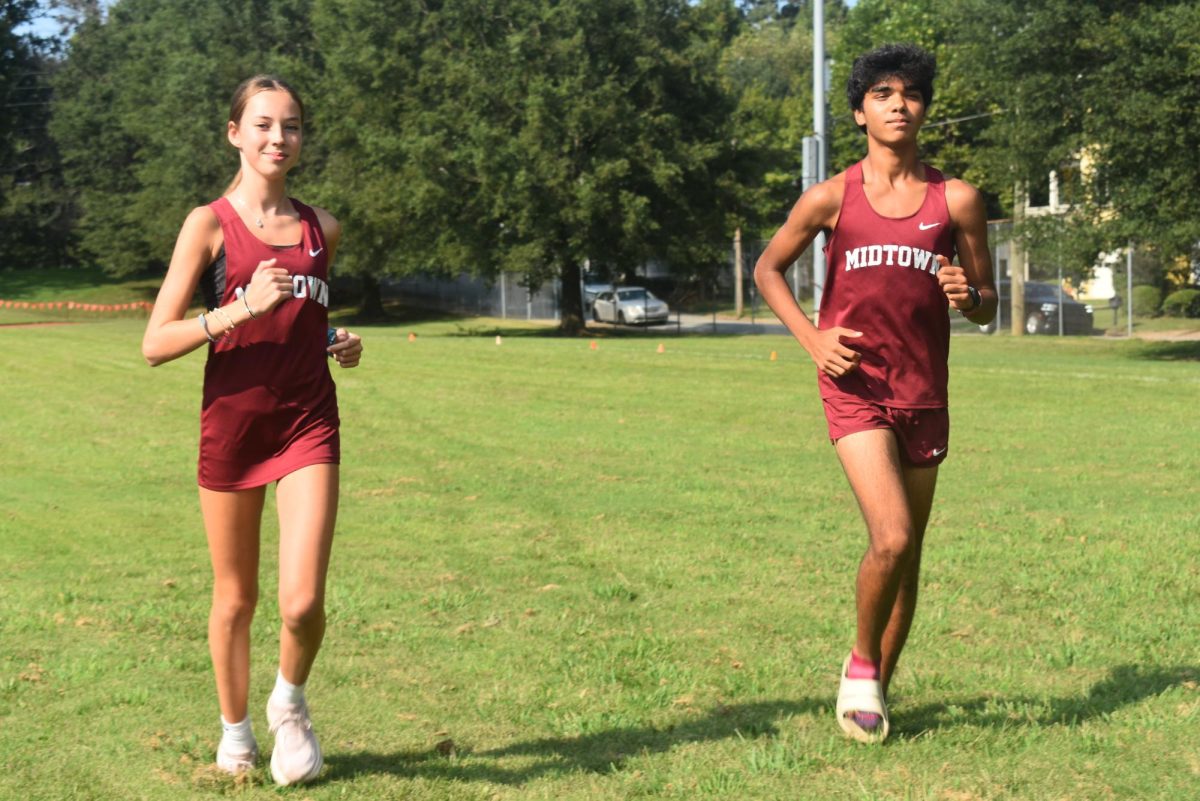Freshman Lia Sinitiere (Left) and Vihaan Devireddy (Right) warm up before their APS series meet at Cheney stadium 