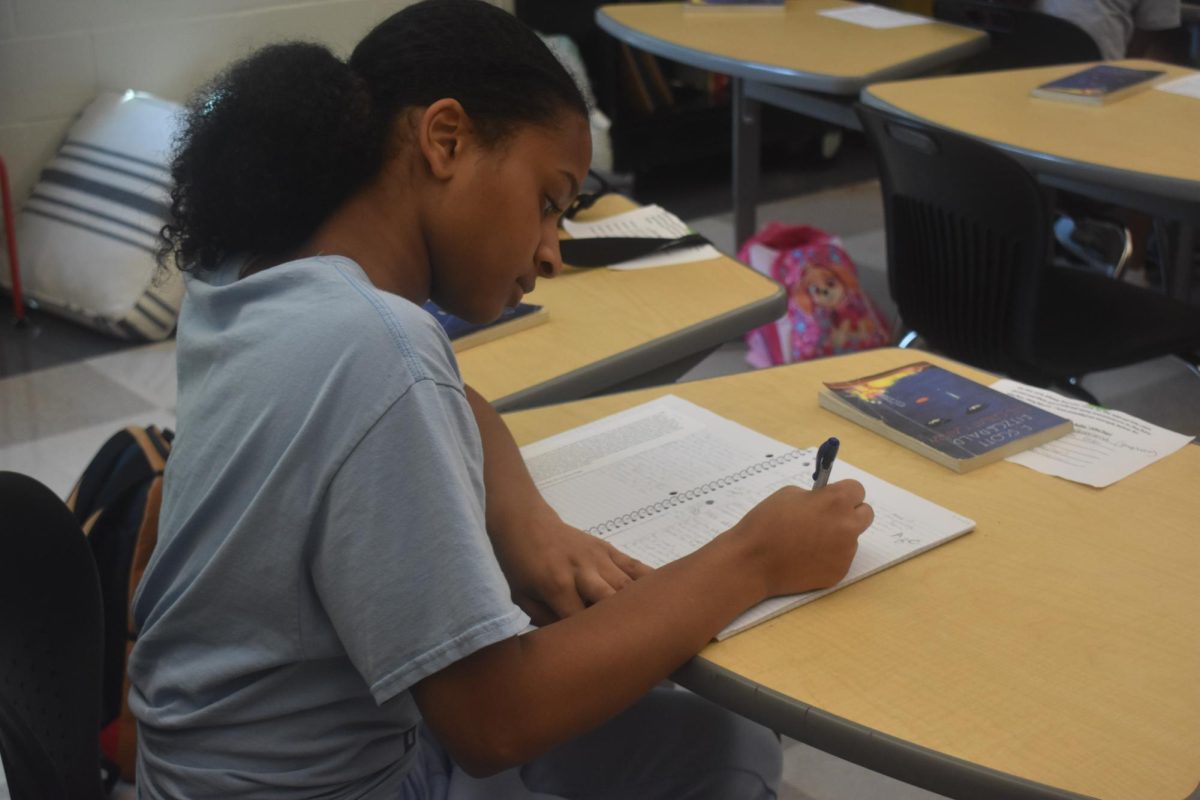 ORIGINAL VOICE: Senior Taylor Matthews, who is in English teacher Erin Aube's Literary Magazine class, works on her handwriting sample assignment.