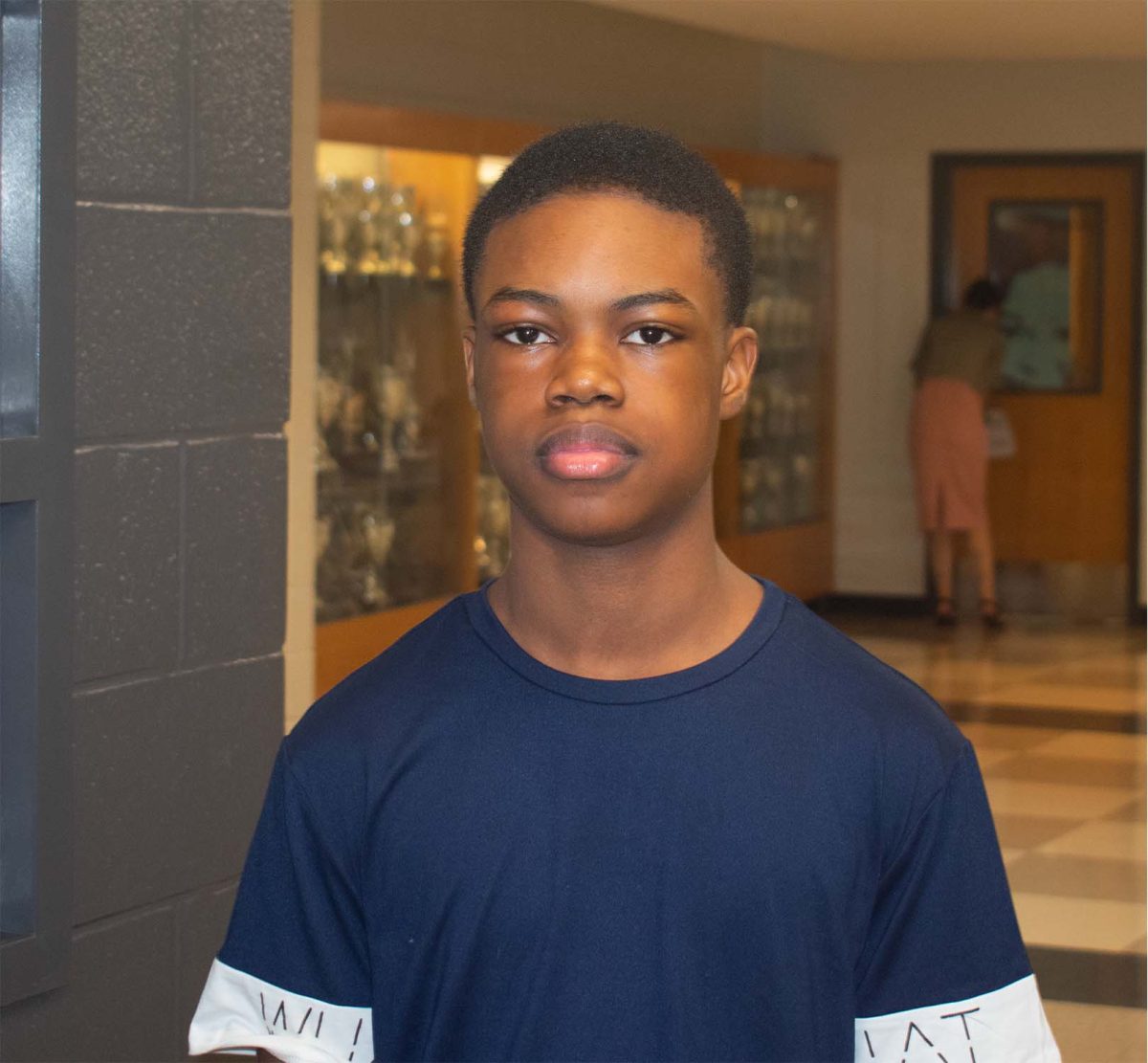 Freshman Daniel Omis stands outside the art classroom in the E100 hallway. 