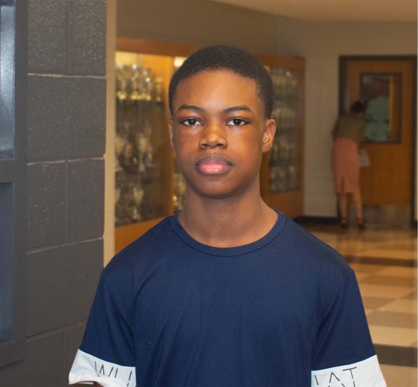 Freshman Daniel Omis stands outside the art classroom in the E100 hallway. 