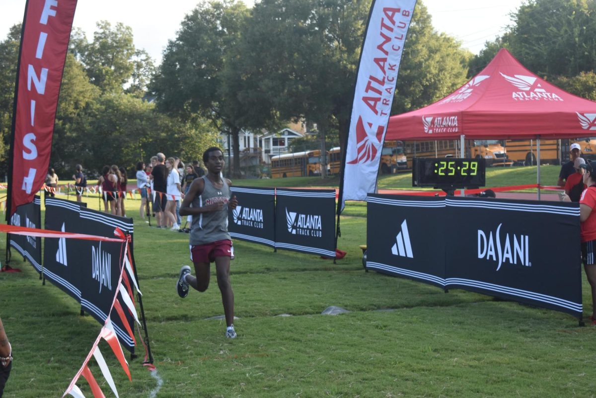 Sophomore Arvid Key-Patel crosses the finish line at the APS series Championships. Midtown placed 3rd overall.