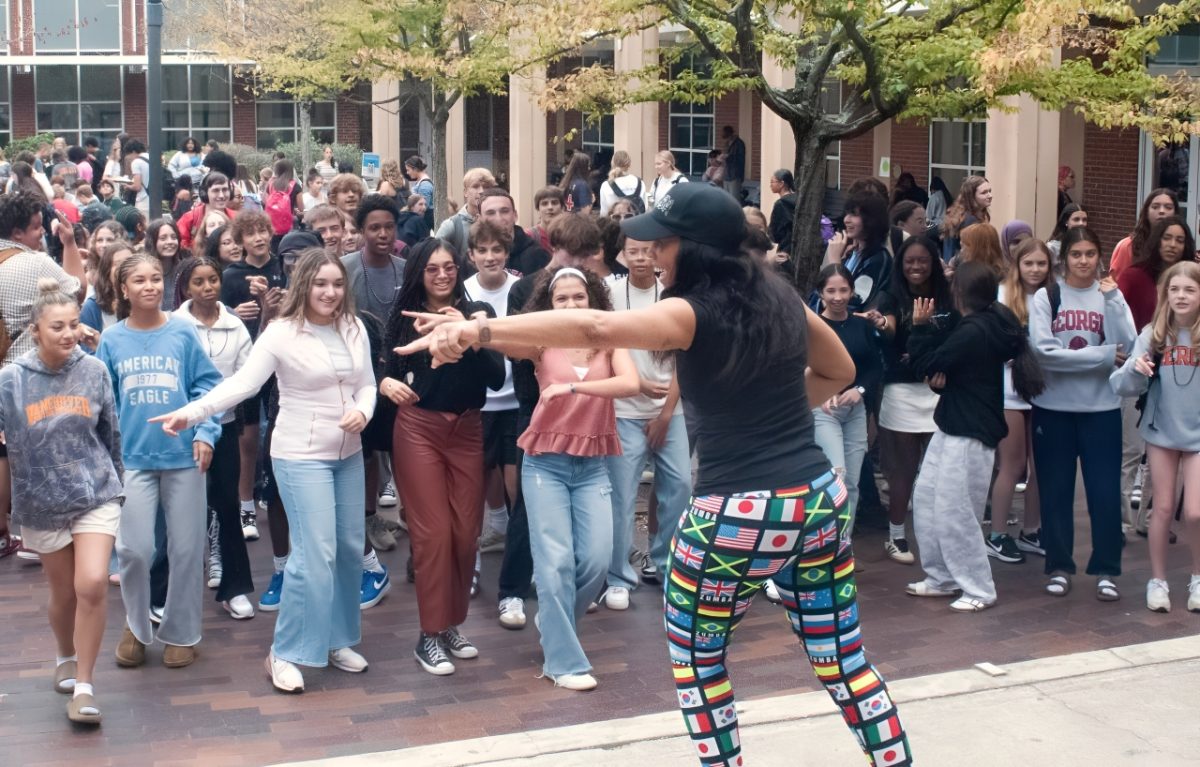 LIVELY LUNCH: Students dance to upbeat Latin music in a Zumba session led by fitness instructor Arnice Hall Foster. The dance workshop highlight's Midtown's Hispanic Heritage Month festivities.
