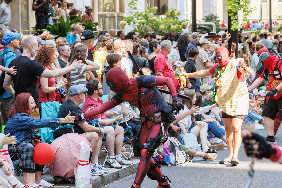 Crowds watch people walk in the Dragon Con parade on Saturday, August 30.