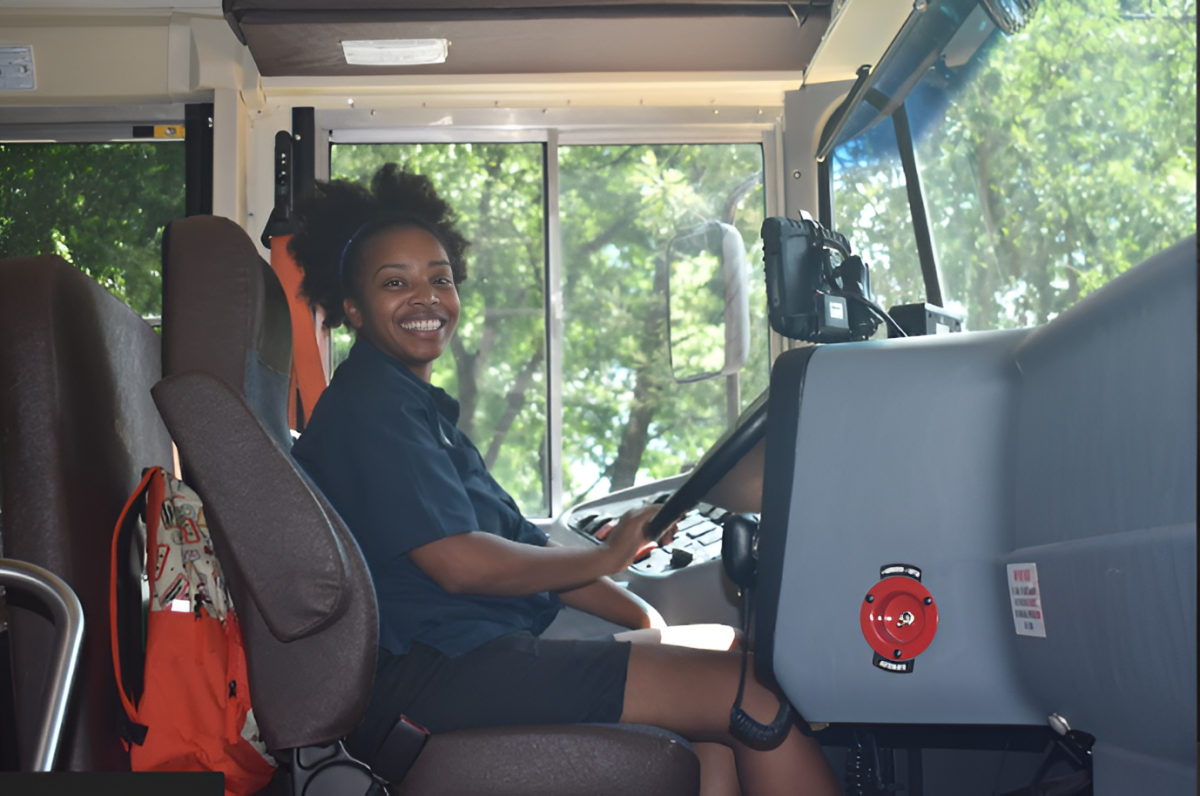 INCREASED INCOME: Atlanta Public Schools bus drivers, along with paraprofessionals and custodians, received 10% pay raises for this school year. Bus drive Jasmine Cooksey welcomes students onto school bus at the end of the the school day on Aug.15.
