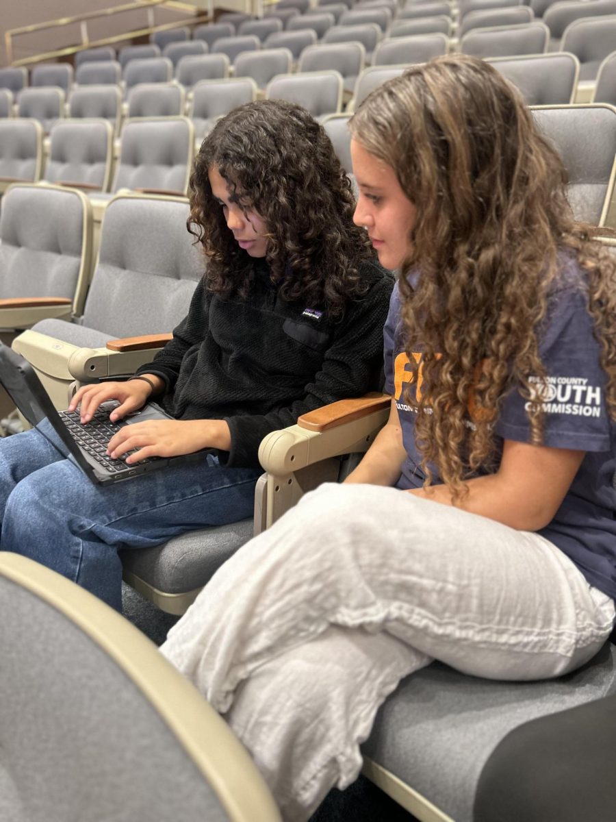 PROJECT PLANNING: Sophomore Abbie Alexander (left) and junior Tegan Derro (right) plan a park beautification initiative.