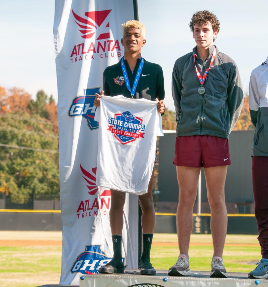 Senior Cameron Collier wears his medal on the podium after winning the championship.