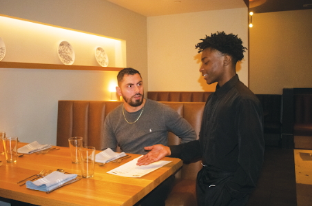 LEARNING LIFE LESSONS: Cafe Momentum Atlanta Intern Sam Smith* practices serving with ground floor manager Avni Aliu. Aliu said the internship aims to instill valuable life skills in its interns such as patience, perseverance, and integrity,