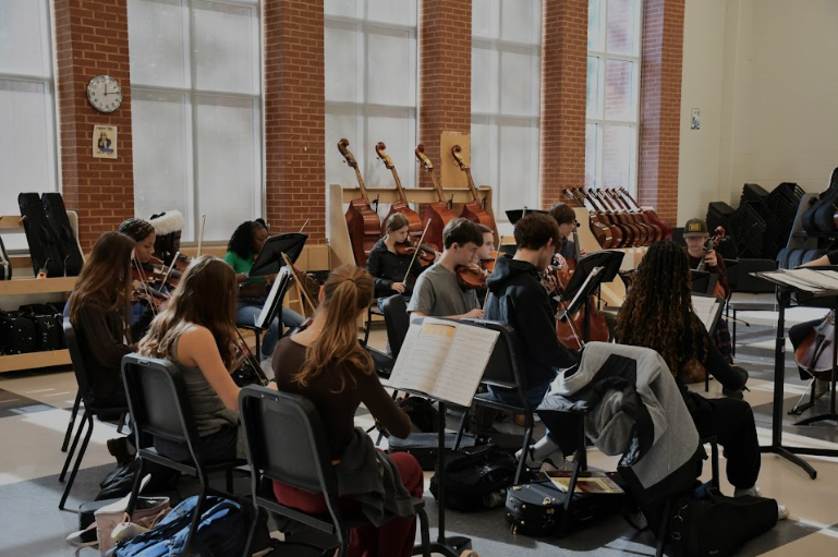 MUSIC ENVIRONMENT: The intermediate orchestra class practices sheet music. Dr. Renfrew said music in school can promote group connections and feelings of belonging.