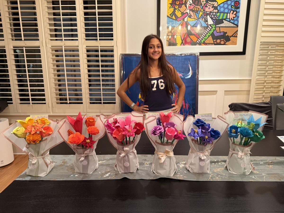 PAPER JOY: Freshman Neha Agarwal with her flower bouquets that she delivered to the Thomas F. Chapman Family Cancer Wellness Center at Piedmont Hospital. Her flower bouquets are going to be displayed in educational spaces for patients.