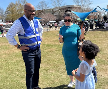 VOTER ENGAGEMENT: Brown speaks to a voter and her child at the taste of Suwanee event that happened March 14. During the event, Brown spoke with constituents during the food festival.