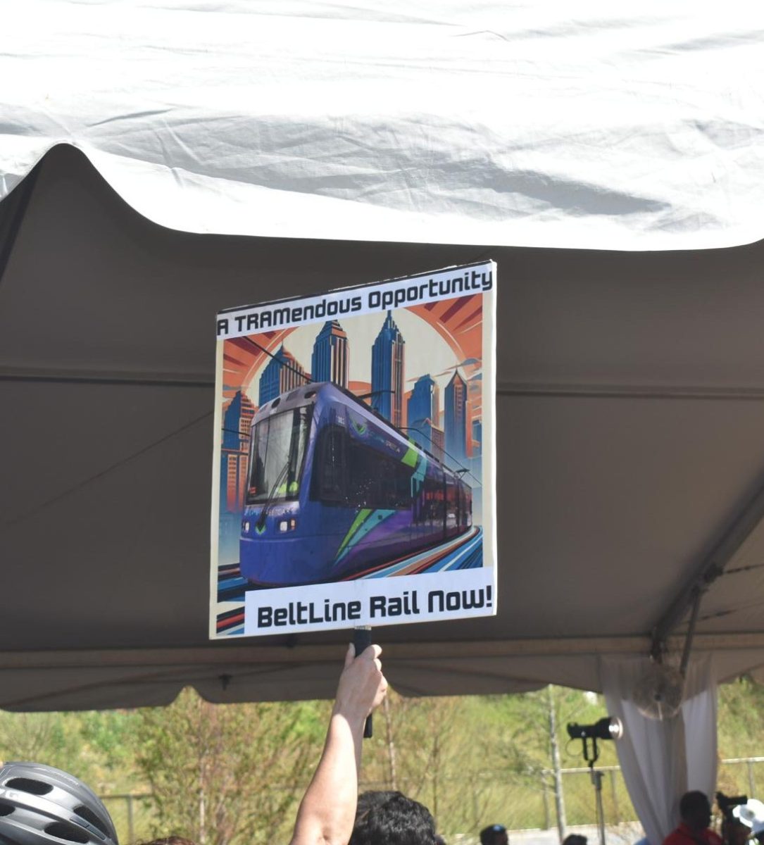 More Than a Path: The Beltline Rail Now nonprofit organization, which promotes the need for free, accessible transportation along the Beltline, held signs supporting Beltline rail while the mayor addressed the crowd.
