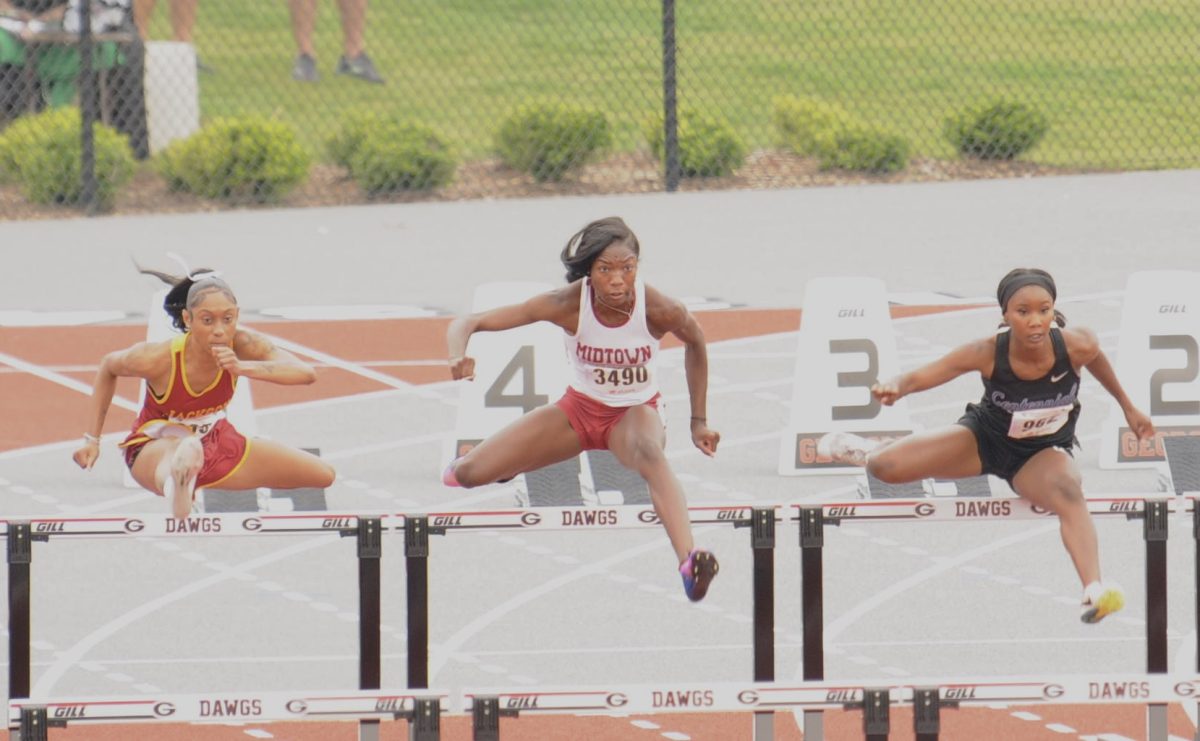 HOPPING HURDLES: Senior DeAsia Burton leaps over a hurdle during the girls 100 meter hurdles at GHSA State Championships on May 11. Burton wound up placing sixth with a PR time of 14.71 and scoring three points for Midtown. 
