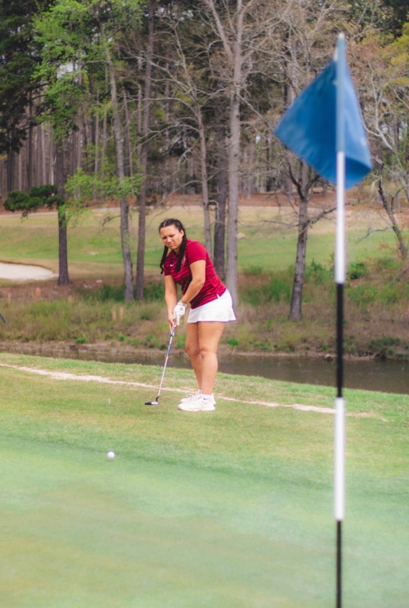 Sophomore Lilly Baird putts onto the green during the area tournament. The Knights lost the tournament ending their season. 