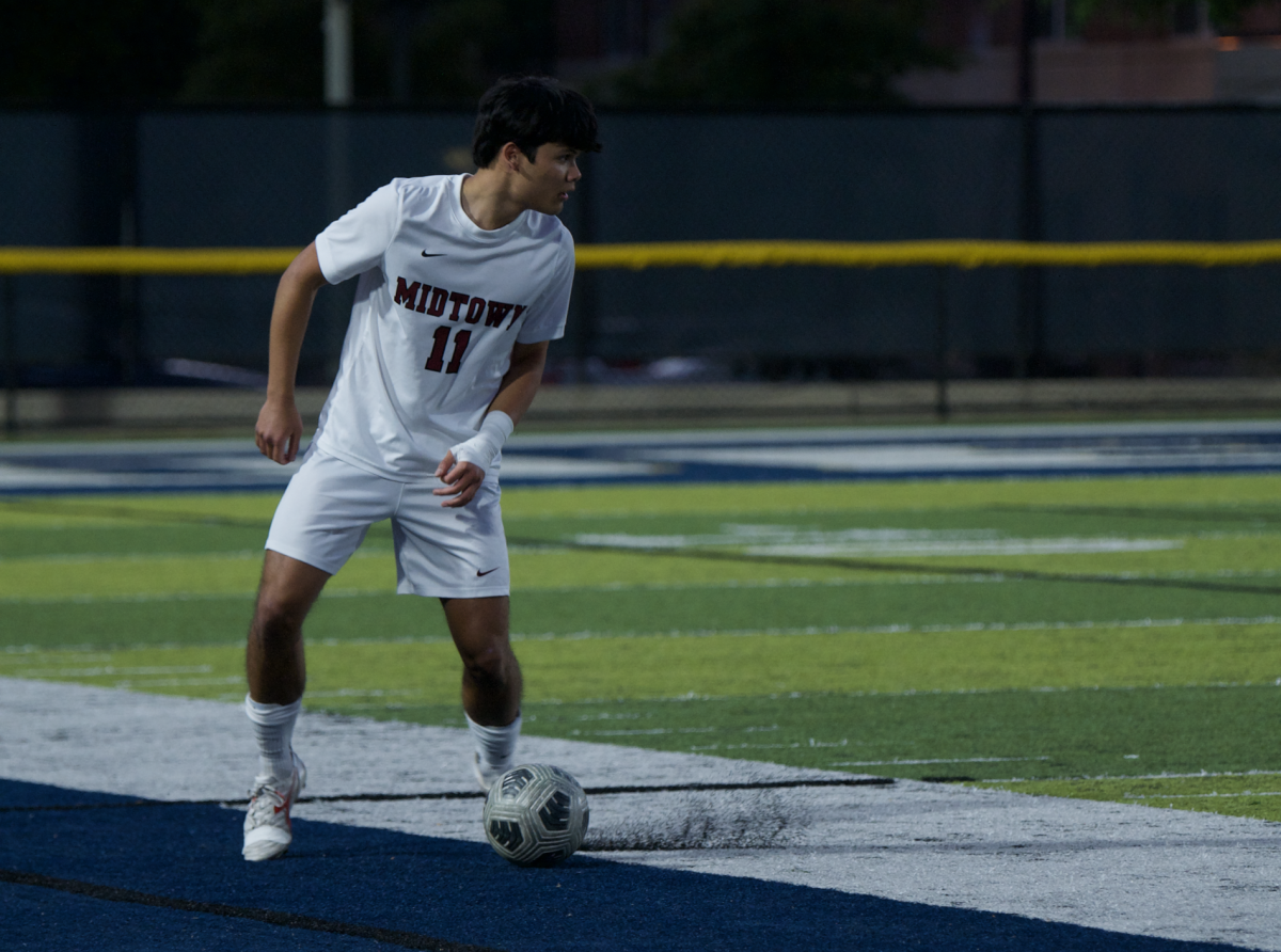  Senior Luka Stankovic shift his body to cross the ball against Decatur on April 16. The Knights lost 4-2.